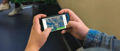 Woman in lab coat, microscope, test tubes, and beakers on a lab bench.
