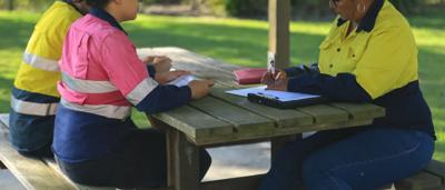 Woman with solar panels, Queensland.