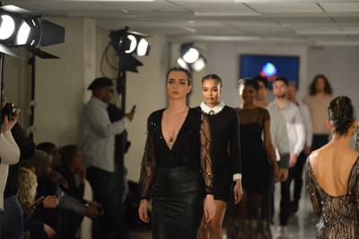 Fashion designer S Pakhrin, headshot, smiling, wearing glasses and a patterned shirt.
