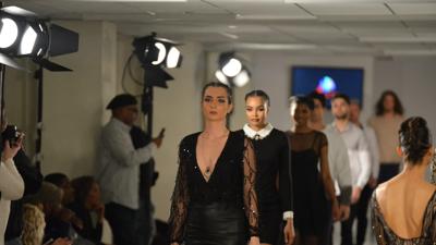 Fashion designer S Pakhrin, headshot, smiling, wearing glasses and a patterned shirt.