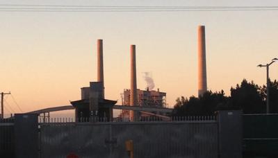 Vales Point Power Station, smokestacks, industrial landscape, blue sky.
