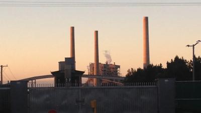 Vales Point Power Station, smokestacks, industrial landscape, blue sky.
