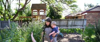 Small business owner in nature, facing risk, with trees and a mountain in the background.