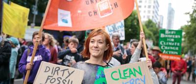 People marching, holding signs, Climate March 2015.