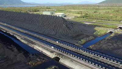 Header image: Abbot Point coal terminal. Large ship loading, blue sky, industrial landscape.