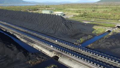 Header image: Abbot Point coal terminal. Large ship loading, blue sky, industrial landscape.