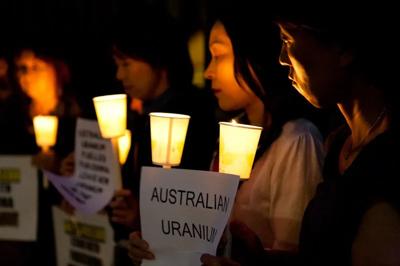 Header image: Fukushima Vigil, people holding candles, night.