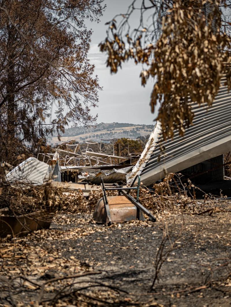 Jim Billings standing in the ruins of his home