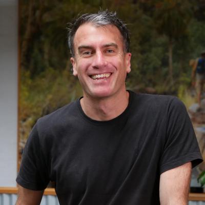 Australian landscape, dry riverbed, eucalyptus trees, blue sky, sunny day.