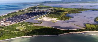Abbot Point coal port. Aerial view. Conveyor, ship loader, and coal stockpiles visible.