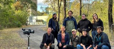 Group of people, outdoor shot, holding a FLIR camera.
