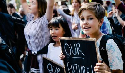Kids striking with signs, protest.