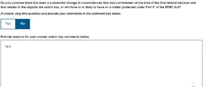 Woman with dark hair, holding a microphone, speaking at a podium.