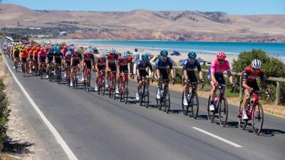 Cyclists riding bikes on a road, header image.