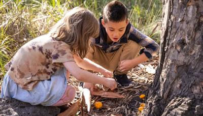 Kids playing outdoors, park setting, sunny day.