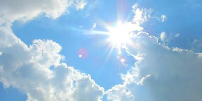 Header image: Blue sky, sun, and clouds over a landscape.