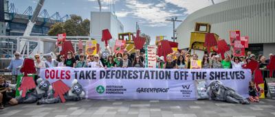 Protest outside Coles AGM 2024. People holding signs, some with megaphone.