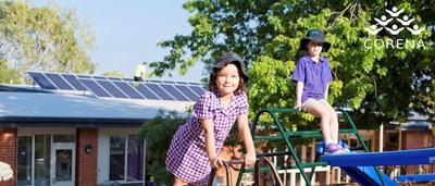 Wind turbines in a field, blue sky, sunny day.