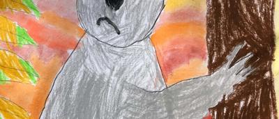 Man painting a vibrant artwork, using brush and palette, outdoors.