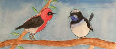 Woman in hijab, smiling, holding a book, outdoors, trees in background.