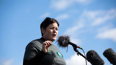 Stop Adani convoy, multiple vehicles, road, desert landscape.