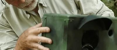 Cropped image of a camera, likely a security camera, mounted on a wall.