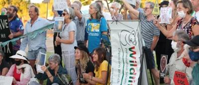 Protest banner, crowd, Australian flag, Capricorn region, climate change demonstration.