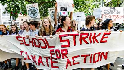 Kids marching, holding signs, protest.
