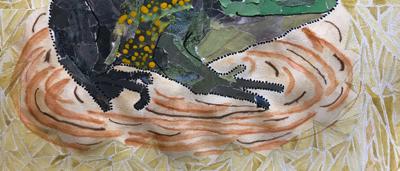 A person in a white shirt stands near a lush green forest, holding a camera.