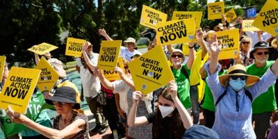Signs with text, people, and a building exterior.