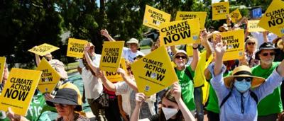 Signs with text, people, and a building exterior.