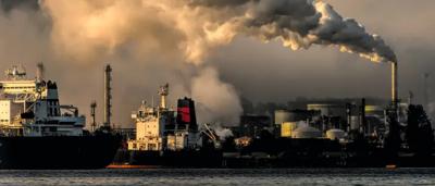 Coal port with ships, cranes, and coal piles.