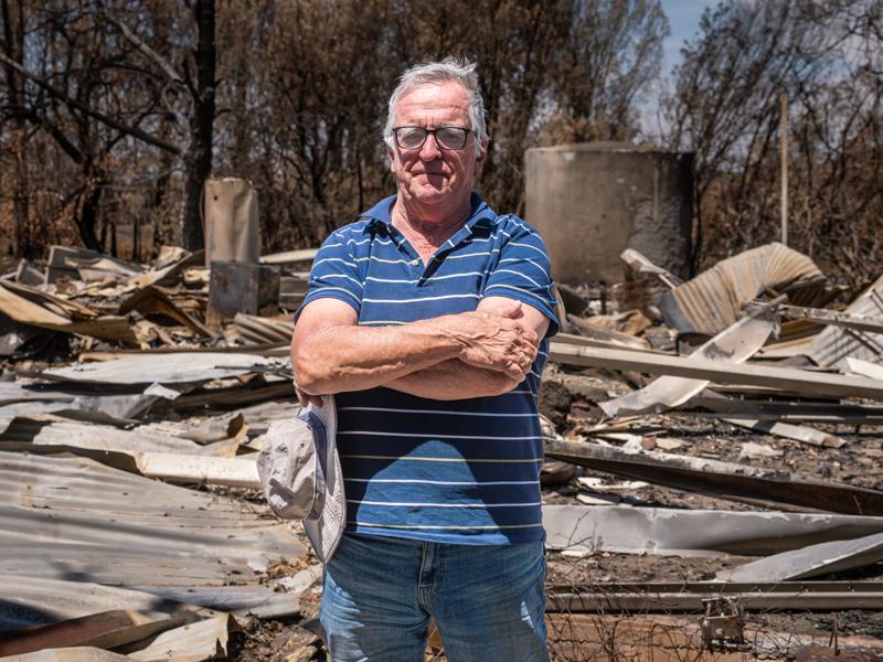 Jim Billings standing in the ruins of his home