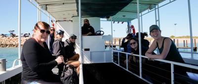 Ocean view with reef, coast, and blue sky.