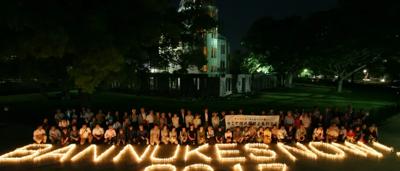 Post-ban nuclear test, mushroom cloud over ocean, ship silhouette.