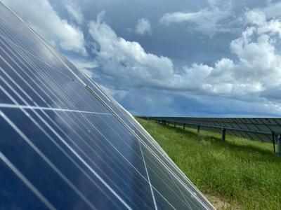 Solar farm in Queensland, Australia. Rows of solar panels, blue sky, built in 2019.