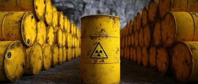 Yellow barrels stacked, possibly containing liquid, outdoors.