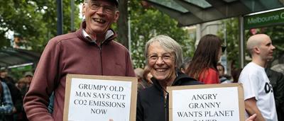 A person standing in a forest, looking at the camera.