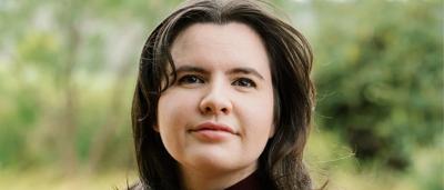 Headshot of Annika Reynolds, smiling, professional attire.