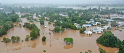 Flood-damaged houses, debris, muddy water, aerial view, Lismore, NSW.