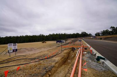 CSI Hunter Valley Singleton: Aerial view, green landscape, buildings, river, and road.
