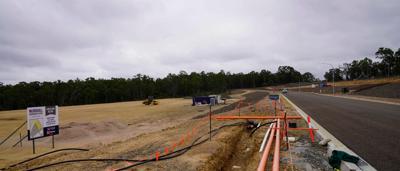 CSI Hunter Valley Singleton: Aerial view, green landscape, buildings, river, and road.