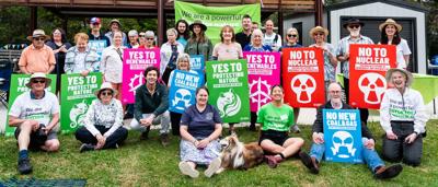 Picnic scene, diverse group, outdoor setting, food, blankets, trees, people smiling.