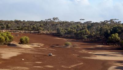 Header image: Kalgoorlie landscape, blue sky, mining infrastructure, and arid terrain.