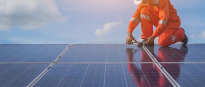Engineer inspecting solar panels in a power plant.