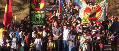 A vibrant landscape with a river, green vegetation, and a cloudy sky.