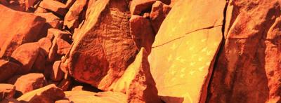 Header image: Murujuga rock art, red ochre paintings on stone, blue sky background.