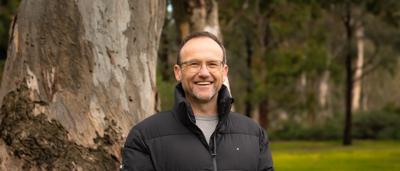 Woman smiling, ACF portrait, announcement graphic, light background.