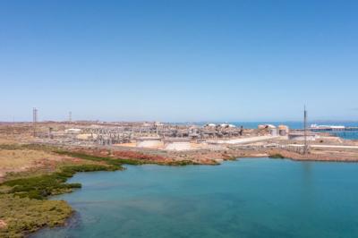 Aerial view of Karratha, Australia. Buildings, roads, and coastline visible.