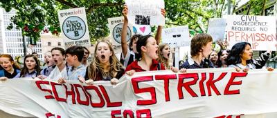 SA Parliament building, exterior view, flags, blue sky.